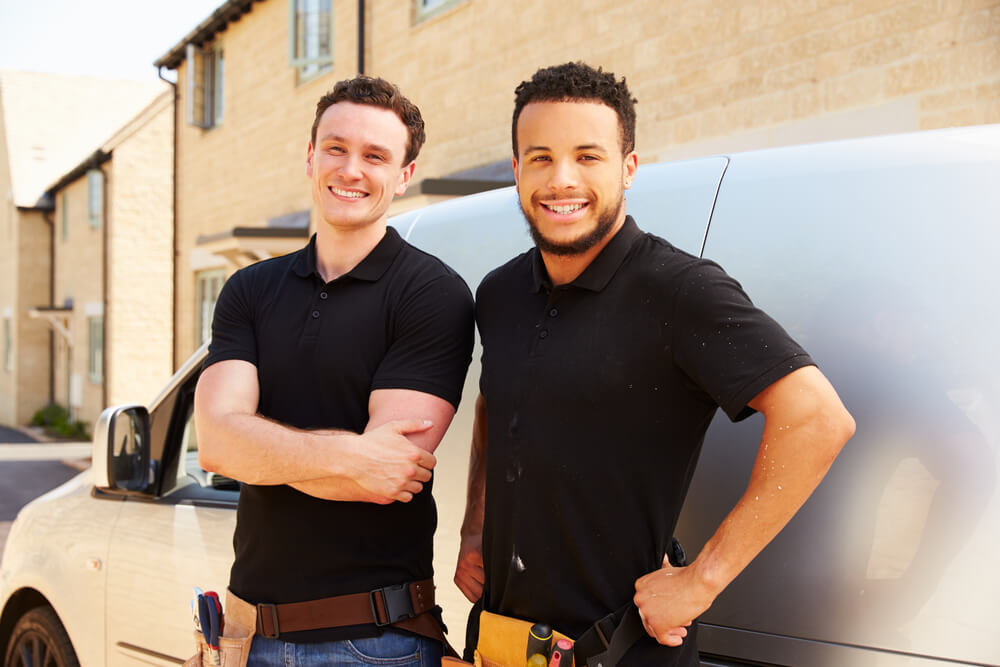 BoilerRight About section two boiler replacement engineers standing next to their van